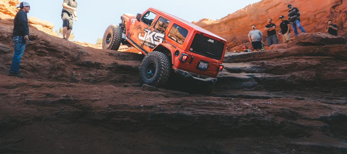 A JKS-equipped Jeep Wrangler climbing a slickrock ledge